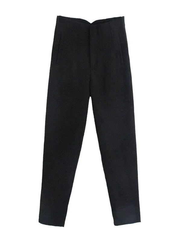 Woman walking confidently in tailored high-waisted slim pants, paired with a tucked-in blouse and loafers, showing elegant everyday style.