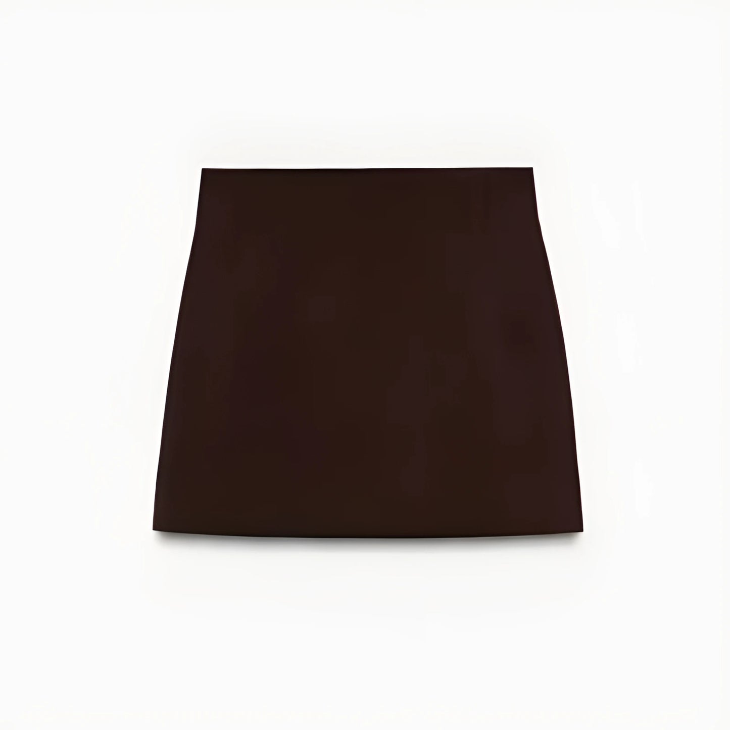 Woman wearing a slim-fit brown blazer jacket and A-line mini skirt in an office setting, confidently presenting in a modern workspace.