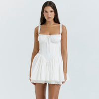 Woman wearing a white dress on a light gray background