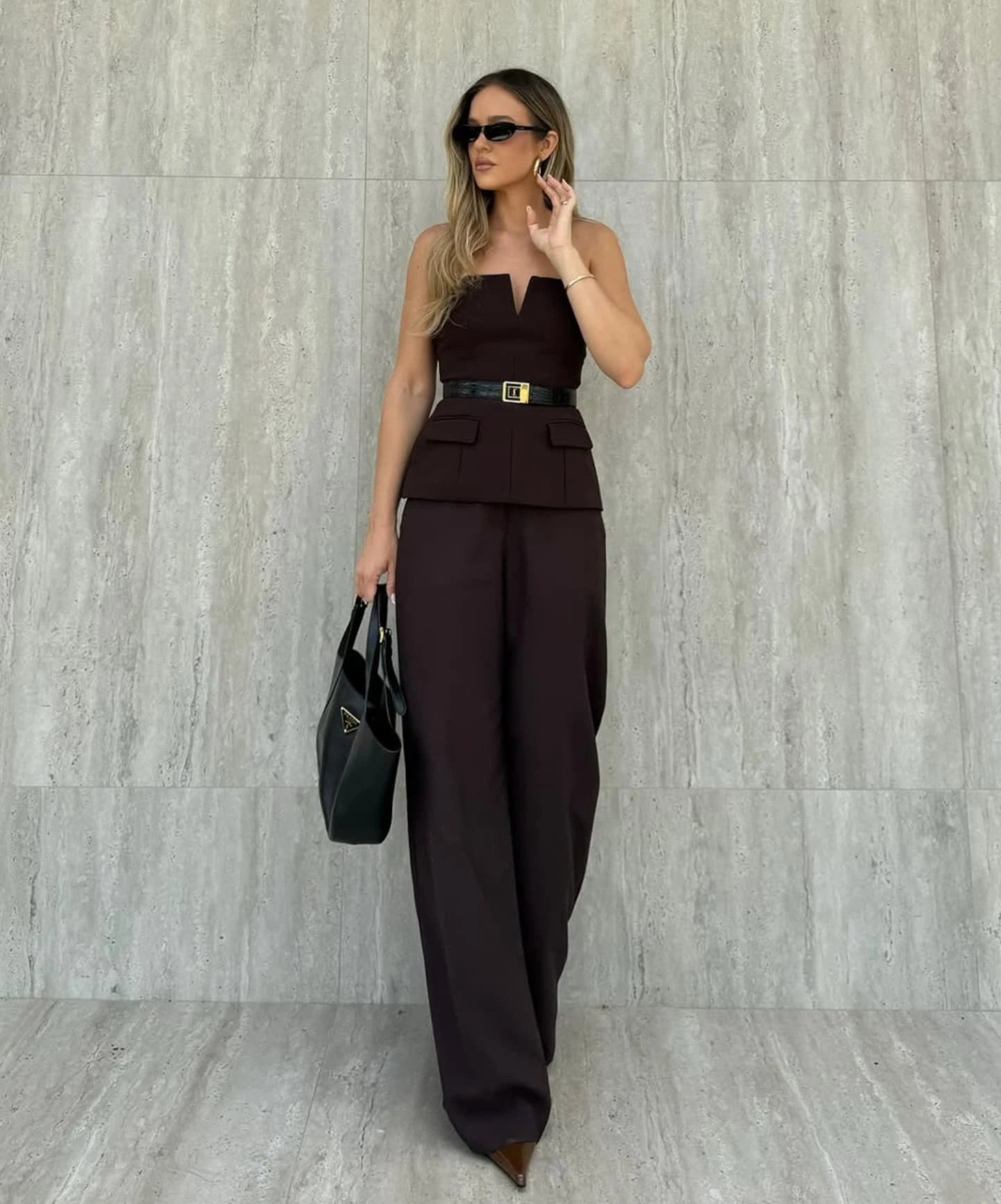 Woman wearing a strapless off white backless crop top, styled for office and club look.