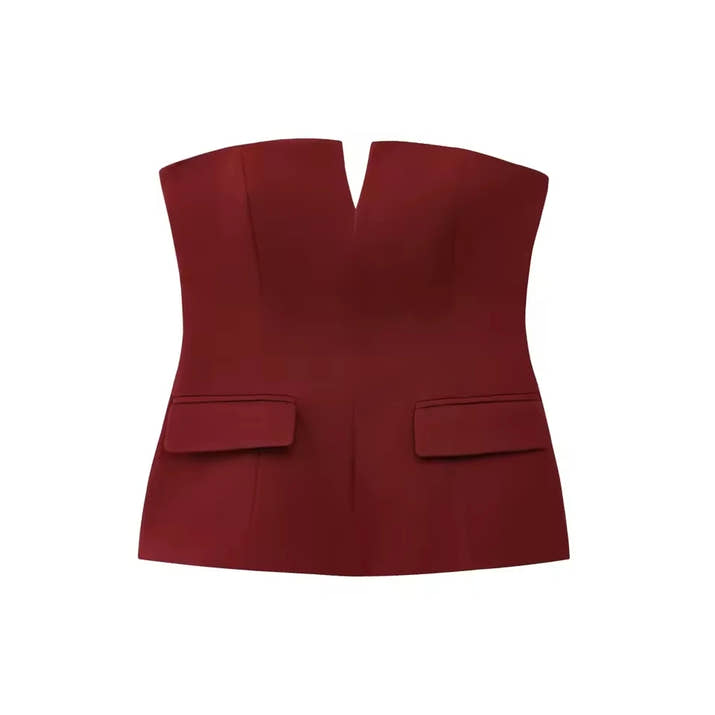 Woman wearing a strapless off white backless crop top, styled for office and club look.