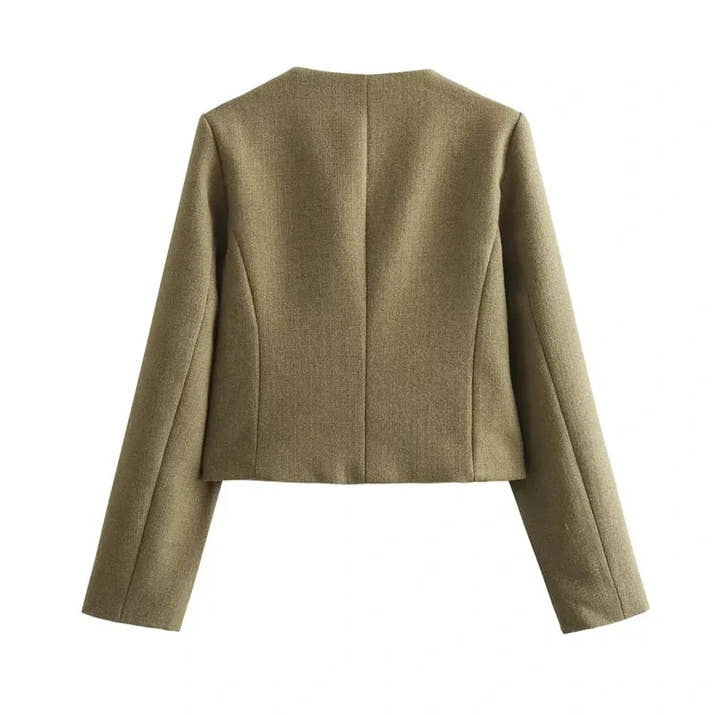 The woman looks casual and chic while walking around the city in a lightly cut khaki double-breasted tweed jacket with buttons.