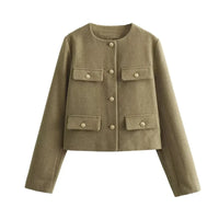 The woman looks casual and chic while walking around the city in a lightly cut khaki double-breasted tweed jacket with buttons.