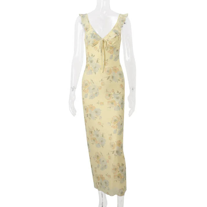 Yellow floral dress on a mannequin against a white background