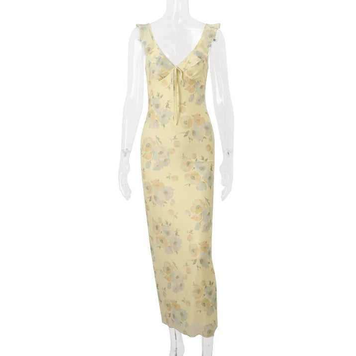 Yellow floral dress on a mannequin against a white background