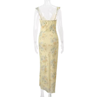 Yellow floral dress on a mannequin against a white background