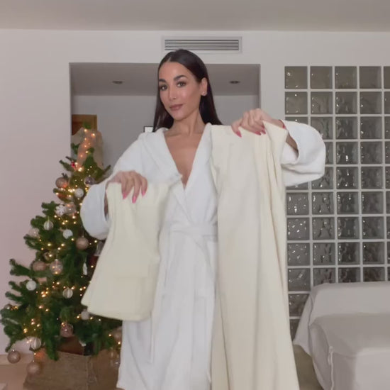 Woman wearing a strapless off white backless crop top, styled for office and club look.