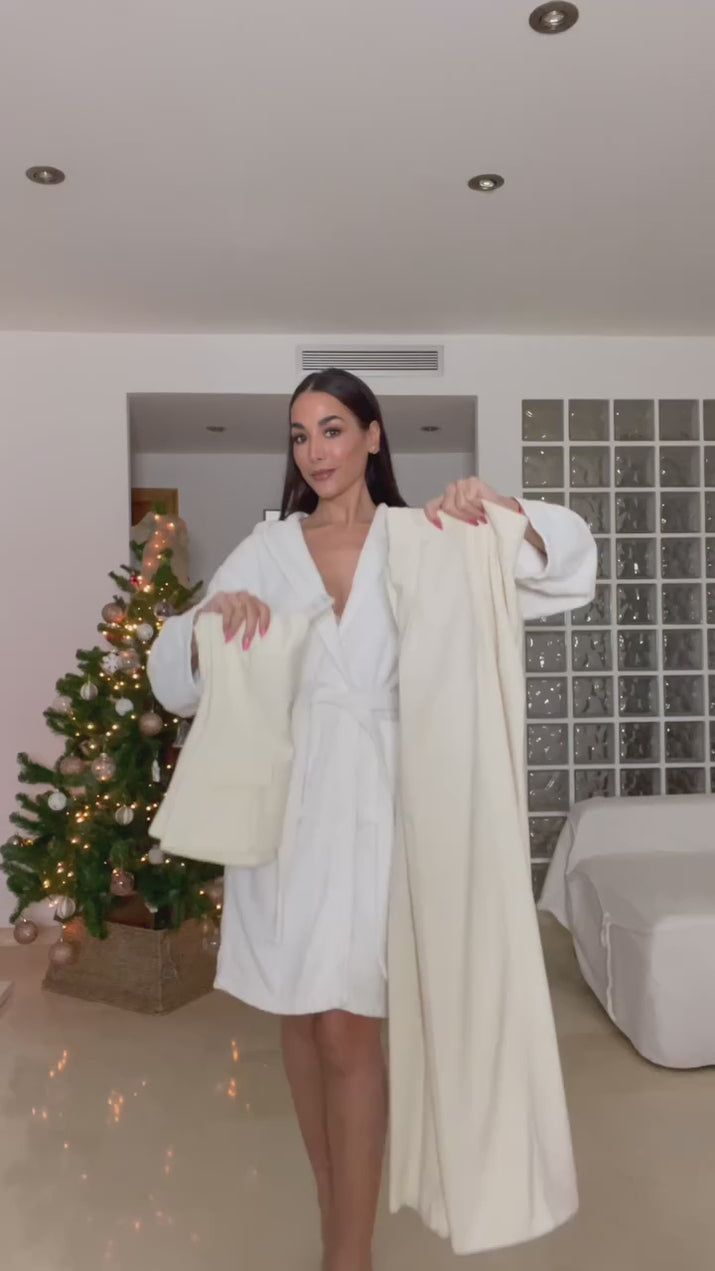 Woman wearing a strapless off white backless crop top, styled for office and club look.