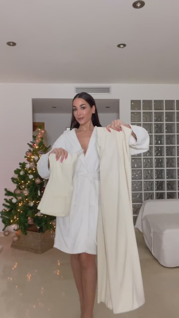 Woman wearing a strapless off white backless crop top, styled for office and club look.