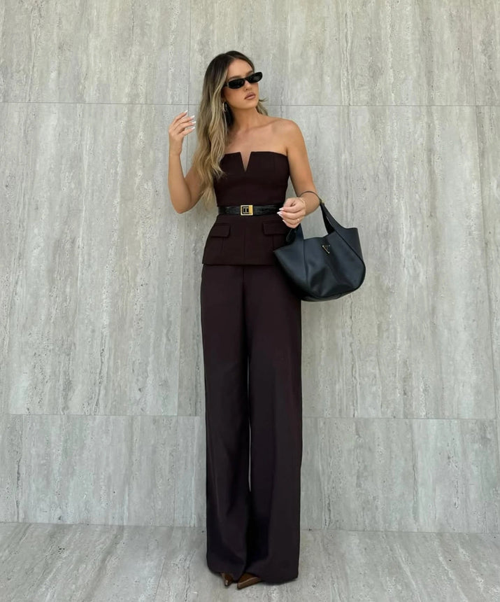 Woman wearing a strapless off white backless crop top, styled for office and club look.