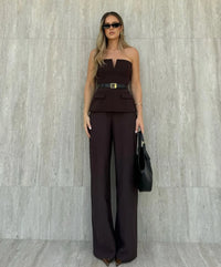 Woman wearing a strapless off white backless crop top, styled for office and club look.