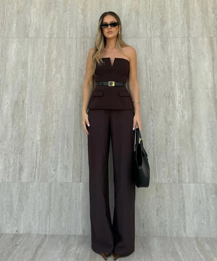 Woman wearing a strapless off white backless crop top, styled for office and club look.