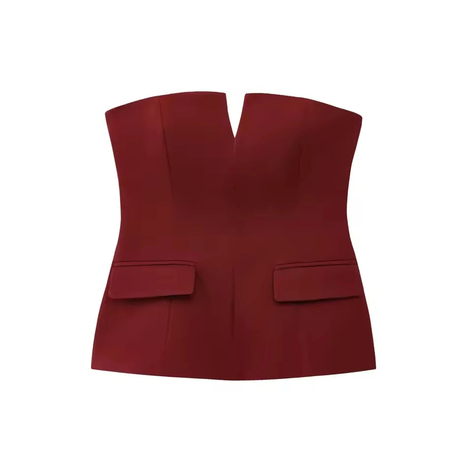 Woman wearing a strapless off white backless crop top, styled for office and club look.