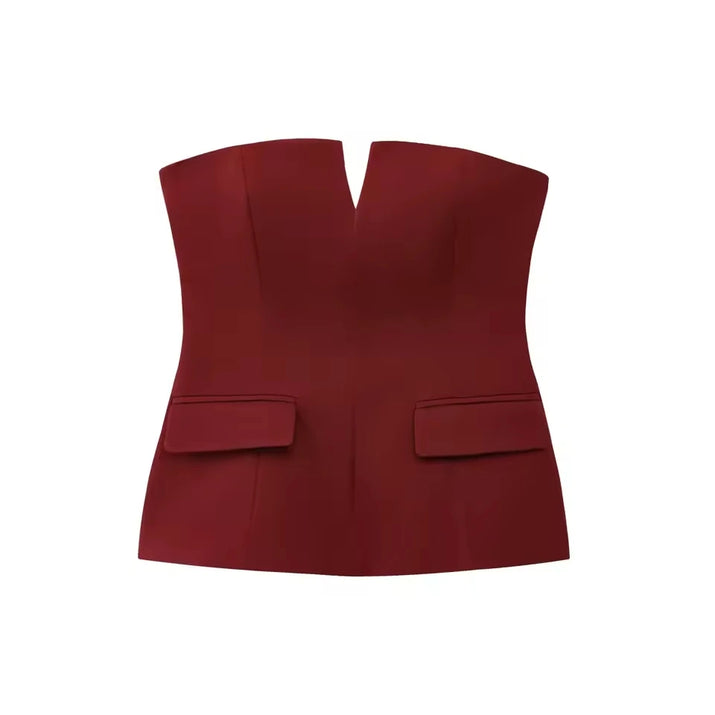 Woman wearing a strapless off white backless crop top, styled for office and club look.