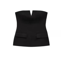 Woman wearing a strapless off white backless crop top, styled for office and club look.