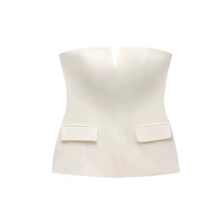 Woman wearing a strapless off white backless crop top, styled for office and club look.